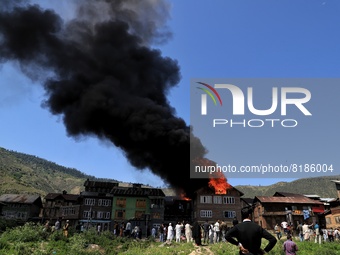 People watch as several houses Gutted in Fire Incident in Baramulla, Jammu and Kashmir India on 07 May 2022 (