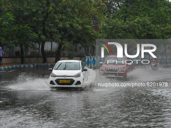 Motorist are seen making there way through a waterlogged road after heavy rainfall due to effects of cyclone ASANI in Kolkata , India , on 9...