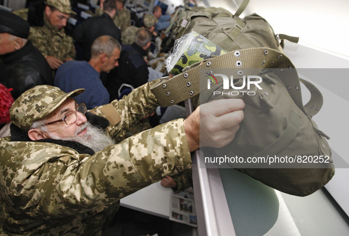 Priest of the Ukrainian Orthodox Church of Kiev Patriarchate wearing military uniforms take place in a train in Kiev on October 2, 2015, to...