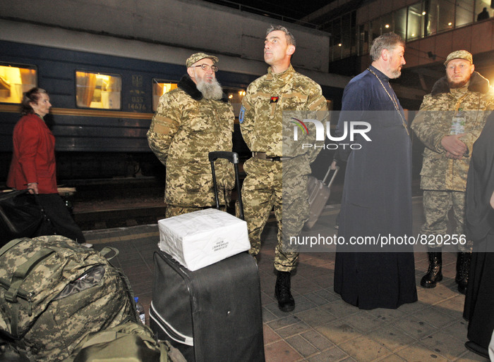 Priest of the Ukrainian Orthodox Church of Kiev Patriarchate wearing military uniforms waiting a train at the railway station in Kiev on Oct...