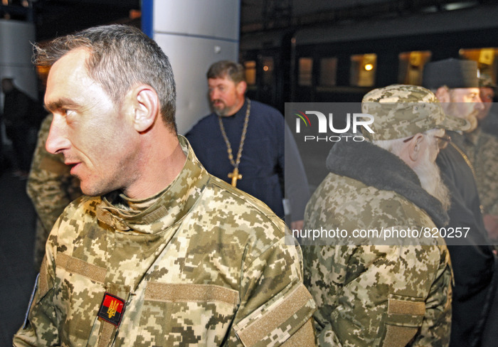 Priest of the Ukrainian Orthodox Church of Kiev Patriarchate wearing military uniforms waiting a train at the railway station in Kiev on Oct...