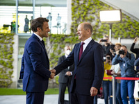 German Chancellor Olaf Scholz greets French President Emmanuel Macron upon his arrival at the Chancellery in Berlin, Germany on May 9, 2022....