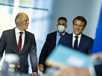 German Chancellor Olaf Scholz and French President Emmanuel Macron arrive to a press conference at the Chancellery in Berlin, Germany on May...