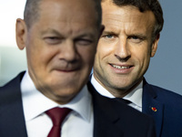 German Chancellor Olaf Scholz and French President Emmanuel Macron arrive to a press conference at the Chancellery in Berlin, Germany on May...