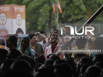 Supporters of Bharatiya Janata Party (BJP) attend in a public rally as Chief minister Himanta Biswa Sarma led alliance Assam Government comp...
