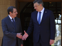 Cyprus' president Nicos Anastasiades, left, shakes hands with Croatian Prime Minister Andrej Plenkovic before their meeting at the president...