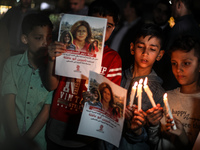 Palestinians light candles during a demonstration in Gaza City on May 11, 2022, in protest against the killing of Al Jazeera journalist Shir...