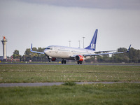 SAS Scandinavian Airlines Boeing 737-800 aircraft as seen during taxiing, rotation, take off and fly phase while departing from Amsterdam Sc...