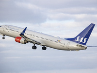 SAS Scandinavian Airlines Boeing 737-800 aircraft as seen during taxiing, rotation, take off and fly phase while departing from Amsterdam Sc...