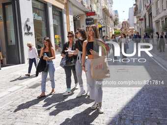 Shoppers walk through the streets of Athens on 12 May 2022. (