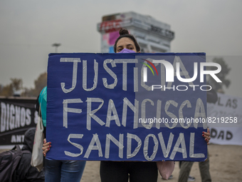 A woman holds a sign with the phrase: -Justice for Francisca Sandoval, in Santiago, Chile, on May 13, 2022 during a demonstration for the de...