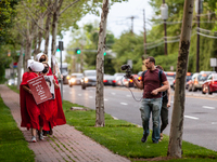 Two people with Breitbart film and harass demonstrators dressed as handmaids from the Handmaid's Tale.  Demonstrators were returning after r...