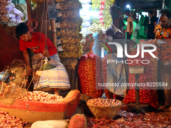 People work at an onion wholesale market in the Kawran Bazar in Dhaka, Bangladesh, May 13, 2022. (