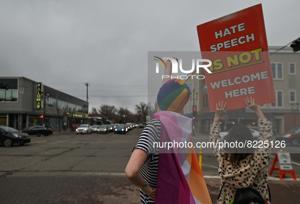 An activist holds a placard with words 'Hate Speech Is Not Welcome Here'.More than 100 local LGBTQ2S + supporters gathered Friday evening a...