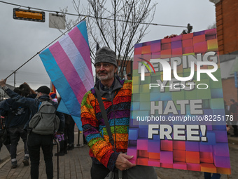 An activist holds a placard with words 'Keeping YEG Hate Free!'.More than 100 local LGBTQ2S + supporters gathered Friday evening at the sou...
