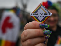 An activist holds a sign 'Pride Corner On Whyte'.More than 100 local LGBTQ2S + supporters gathered Friday evening at the southeast corner o...