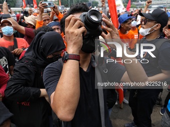 A Photojournalist that also part of labor during his covrrage at location. labor held may day in front of house of representatives, the even...