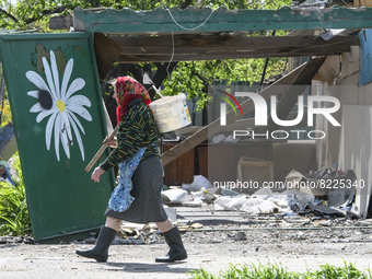 Local woman passes near the residental house destroyed by russian army airstrike in the Borodianka town, Kyiv area, Ukraine May 13, 2022 (Ph...