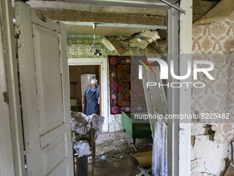 Local resident Tetiana stands inside her house damaged during the Russian occupation of Zahaltsi village near Kyiv, Ukraine, ​May 13, 2022....
