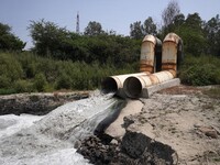 A sewage drain with chemical foam from industrial effluents finds its way into the revered Yamuna river, in New Delhi, India on May 14, 2022...