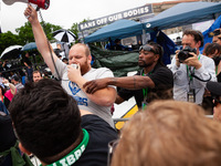 A counter-protester is grabbed by security after shoving and hitting people attending the Band Off Our Bodies march, the flagship event of a...