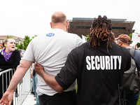 Security escorts a counter-protester out of the Bans Off Our Bodies march, after he shoved and hit attendees.  The protest is the flagship e...