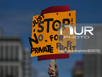 A protester holds a placard with words 'Just STOP. No For Private Profit'.
Health-care workers, activists and their supporters protested thi...