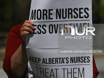 A protester holds a placard with words 'More Nurses Less Overtime!'.
Health-care workers, activists and their supporters protested this afte...
