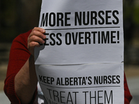A protester holds a placard with words 'More Nurses Less Overtime!'.
Health-care workers, activists and their supporters protested this afte...
