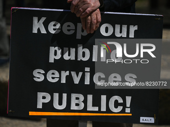 A protester holds a placard with words 'Keep our public services PUBLIC!'.
Health-care workers, activists and their supporters protested thi...