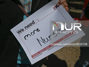 A protester holds a placard with words 'We need more Nurses!'.
Health-care workers, activists and their supporters protested this afternoon...
