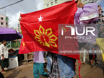 A young demonstrator holds a flag during an anti-coup protest in Yangon, Myanmar on May 16, 2022.
 (