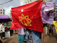 A young demonstrator holds a flag during an anti-coup protest in Yangon, Myanmar on May 16, 2022.
 (