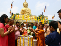 Indian Buddhist devotees pray at a statue of the Buddha during Buddha Purnima, which marks Gautama Buddha's birth anniversary, At Howrah, We...