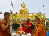 Indian Buddhist Monks offer prayers at a statue of the Buddha during Buddha Purnima, which marks Gautama Buddha's birth anniversary, At Howr...