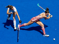 Agustina Albertarrio (R) of Argentina competes for the ball with Maria Lopez of Spain during the FIH Hockey Pro League Women game between Sp...
