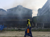 Women and children are vulnerable condition an air polluted area as smoke rises from a re-rolling mill in Dhaka, Bangladesh, May 16, 2022. (
