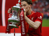 Liverpool's Kostas Tsimikas kisses  the FA Cup after their sides 6-5 penalty shoot-out after a 0-0 draw in normal time FA Cup Final between...