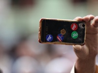 A man records a video from a phone with Jio Mobile sticker on its back in Baramulla, Jammu and Kashmir, India on 17 May 2022. (