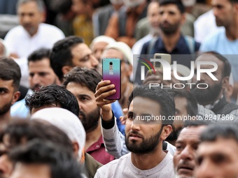 People listen to senior political leader and Former Deputy Chief Minister of Jammu and Kashmir Muzaffar Hussain Baig during a political rall...