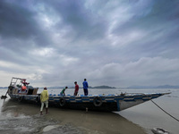  A boat arrives on the banks of Brahmaputra river to carry goods, in a cloudy day, in Guwahati, Assam, India on 17 May 2022.  (