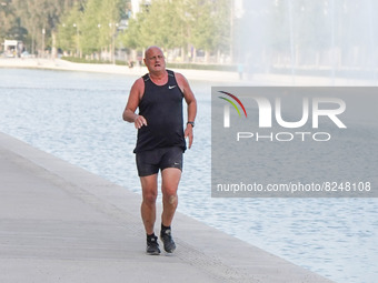 A man runs at Stavros Niarchos Cultural Centre in Athens on 17 May 2022. (
