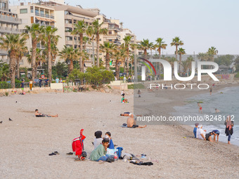 People enjoy the warm weather on Athens beach in Athens on 17 May 2022. (