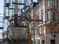 Next to a crucifix, a statue is covered to protect it from potential missile strikes in Lviv on May 19, 2022. Although Lviv has not suffered...