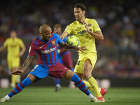 Dani Alves of Barcelona and Alfonso Pedraza of Villarreal compete for the ball during the LaLiga Santander match between FC Barcelona and Vi...