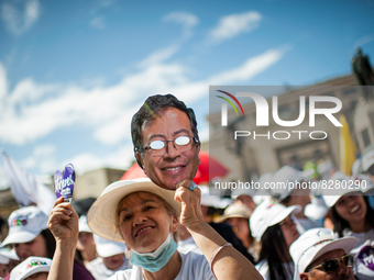 A supporter of Gustavo Petro holds a cut-out face of the candidate during the closing campaign rally of left-wing presidential candidate for...