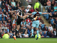 Dan Burn of Newcastle Unitedcontests a header with Burnley's Ashley Barnes  during the Premier League match between Burnley and Newcastle Un...