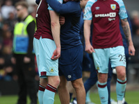 Nathan Collins of Burnley is consoled by a member of the backroom staff after their defeat and relegation  during the Premier League match b...