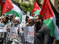 Protestors wave Palestinian flags while chanting anti-Israeli slogans during a protest against a march by Jewish ultranationalists through e...