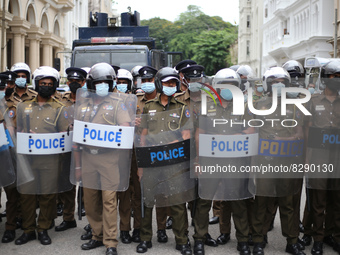 Sri Lankan riot police personnel stand guard near the Presidential House in Colombo, Sri Lanka, May 24, 2022. People protested against the g...